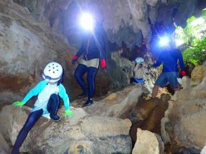 西表島の鍾乳洞ケイビング体験をする子供たち