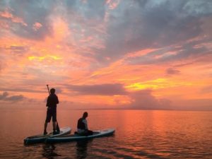 supの上で夕日を眺めるカップル